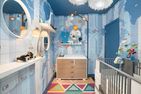 a room with toys and baby crib