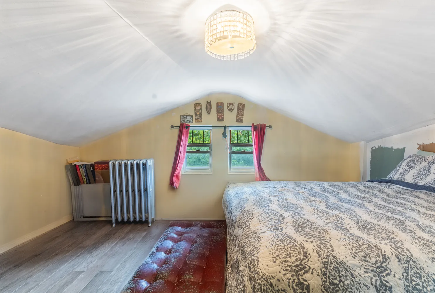a view of a bedroom with wooden floor and windows
