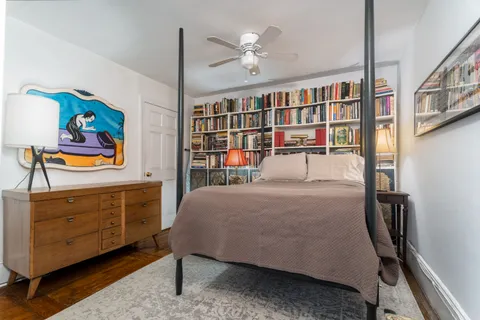 a bedroom with furniture and a dresser
