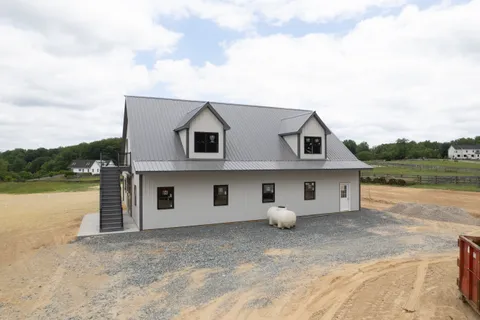 a view of a house with swimming pool and porch
