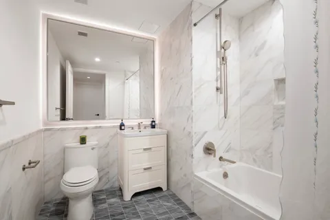 a bathroom with a sink toilet and shower