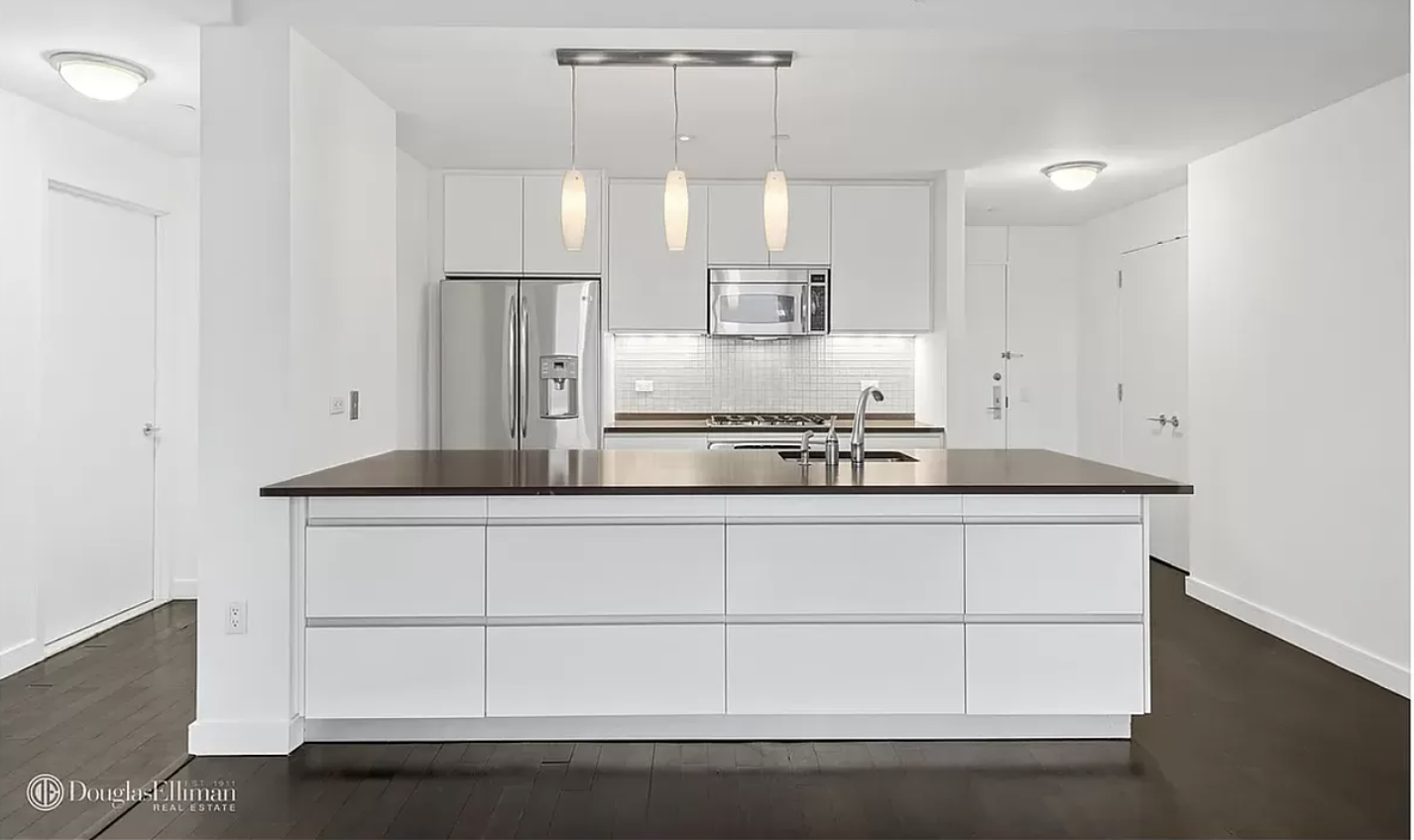 306 Gold Street, Unit 31E Brooklyn, NY 11201 - Photo 2 of 15 a kitchen with stainless steel appliances a refrigerator and white cabinets