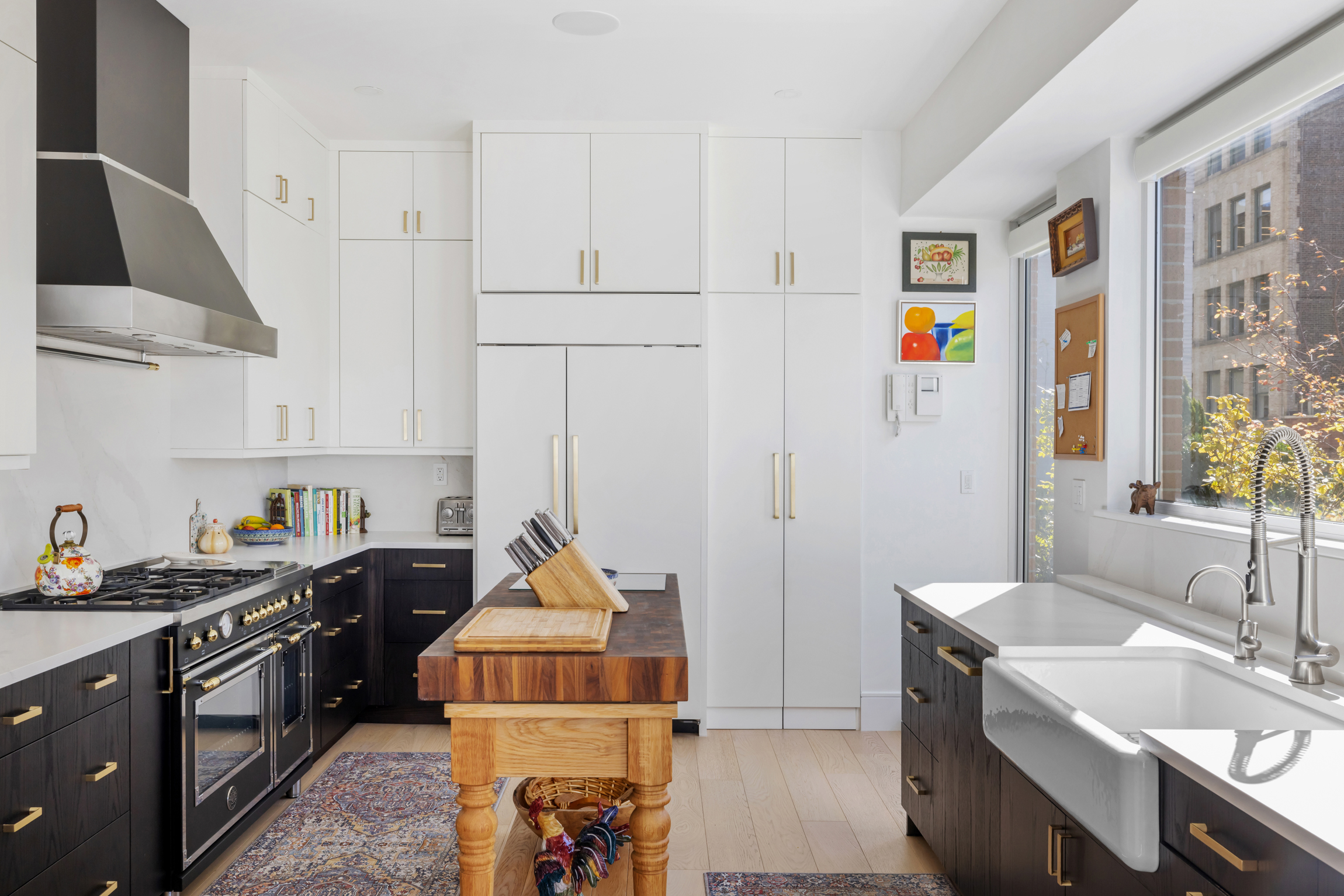 63 West 17th Street, Unit 7A Manhattan, NY 10011 - Photo 5 of 32 a kitchen that has a sink and a stove