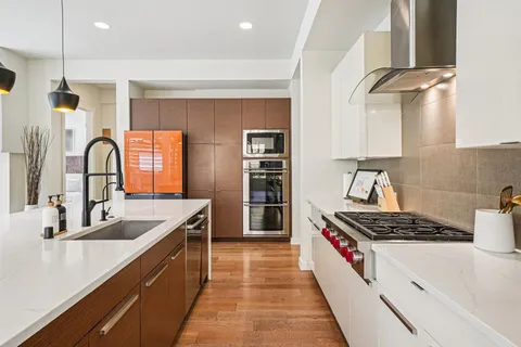 a kitchen with sink a stove and refrigerator
