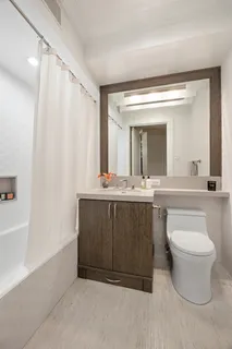 a bathroom with a double vanity sink and a mirror