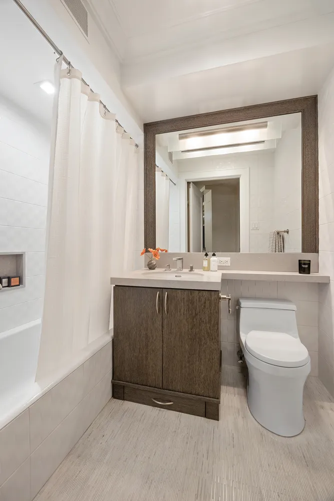 a bathroom with a double vanity sink and a mirror