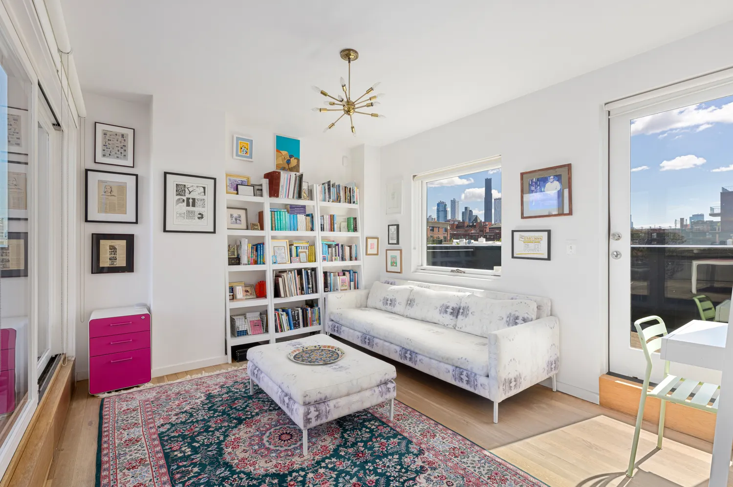a living room with furniture a rug and a bookshelf