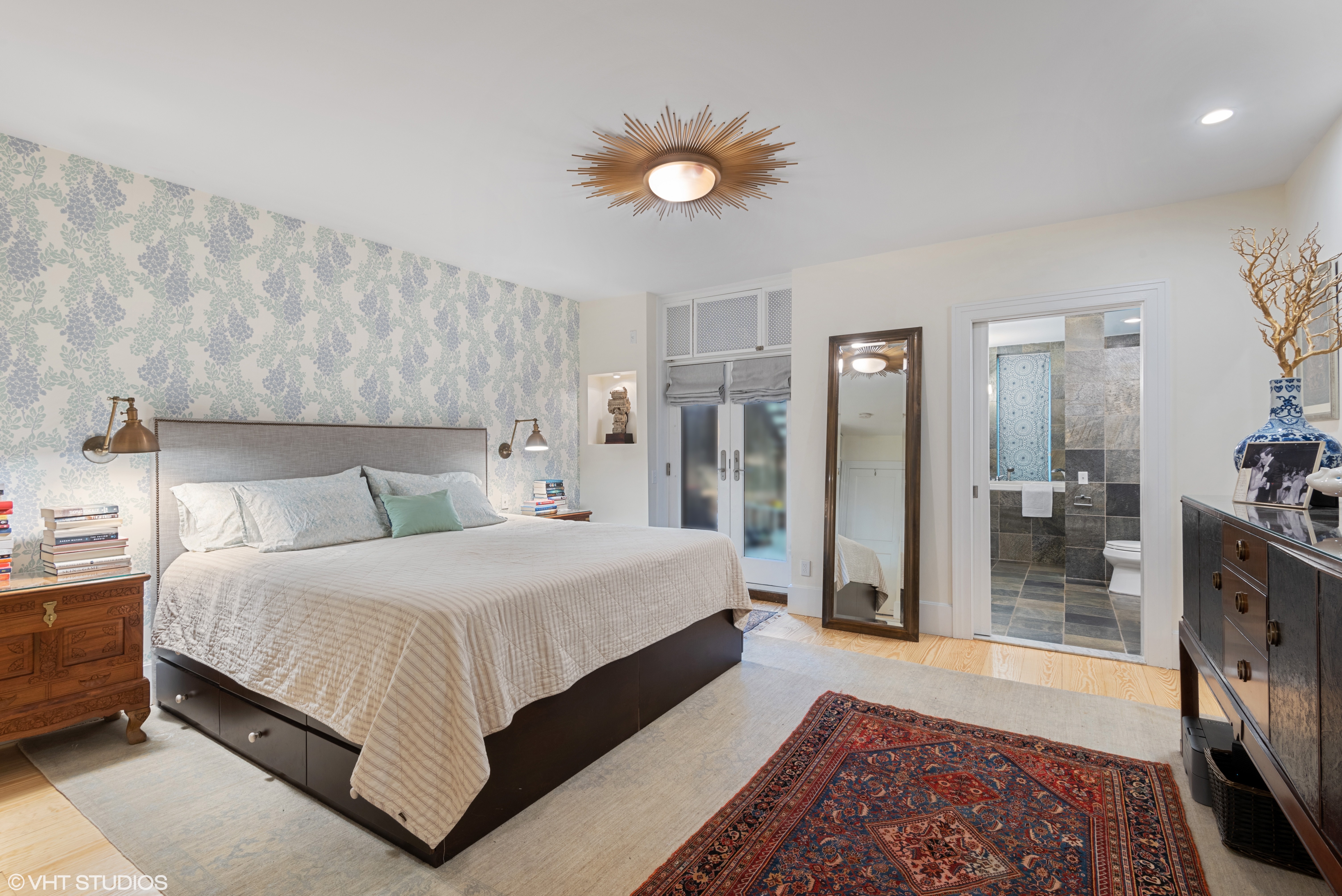 353 West 120th Street, Unit 1 Manhattan, NY 10027 - Photo 2 of 8 a bedroom with a bed and a lamp on table