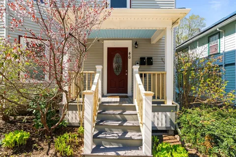 a front view of a house with a garden