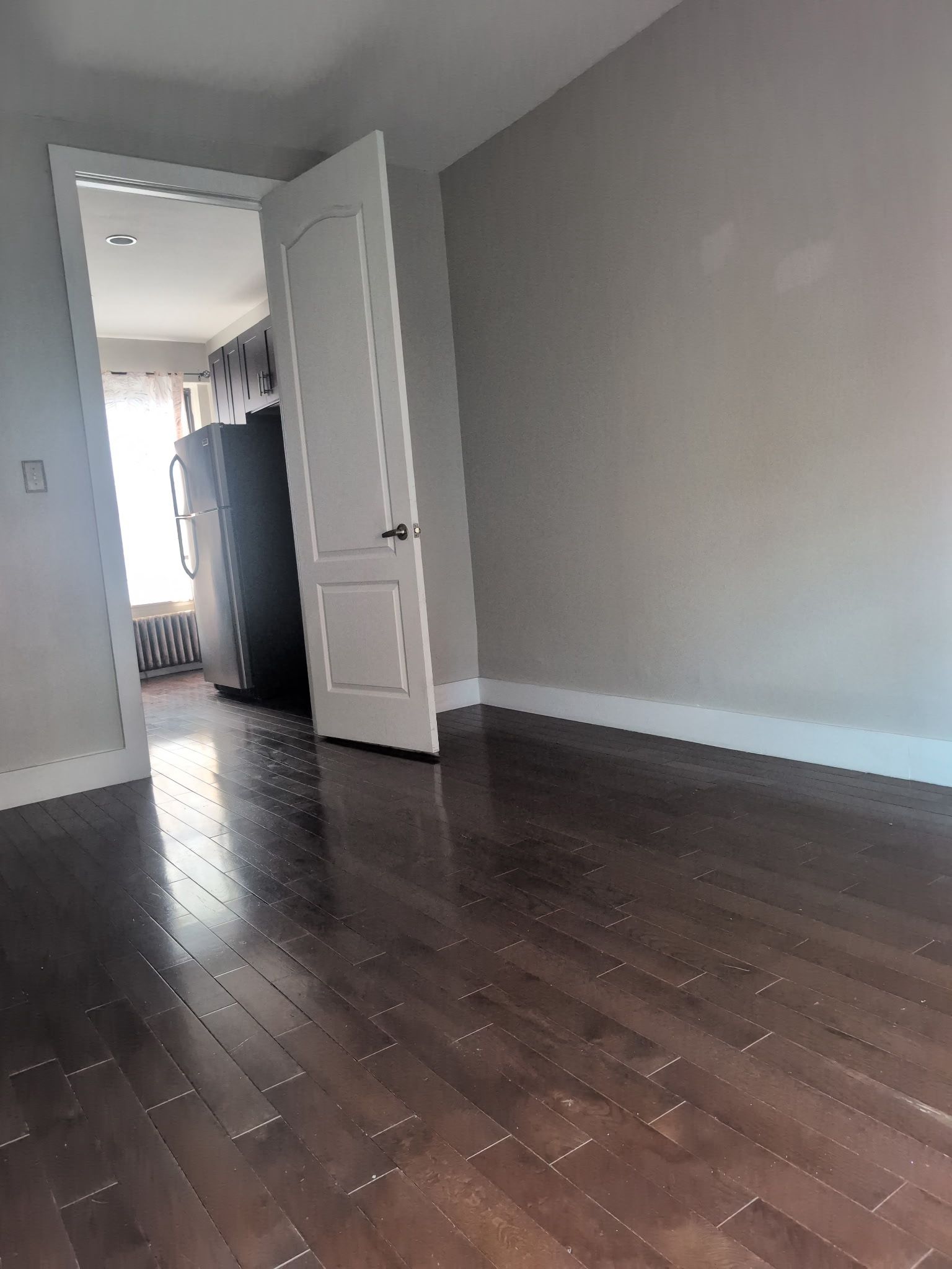 2405 Nostrand Avenue, Unit 6 Brooklyn, NY 11210 - Photo 5 of 11 an empty room with wooden floor and stairs