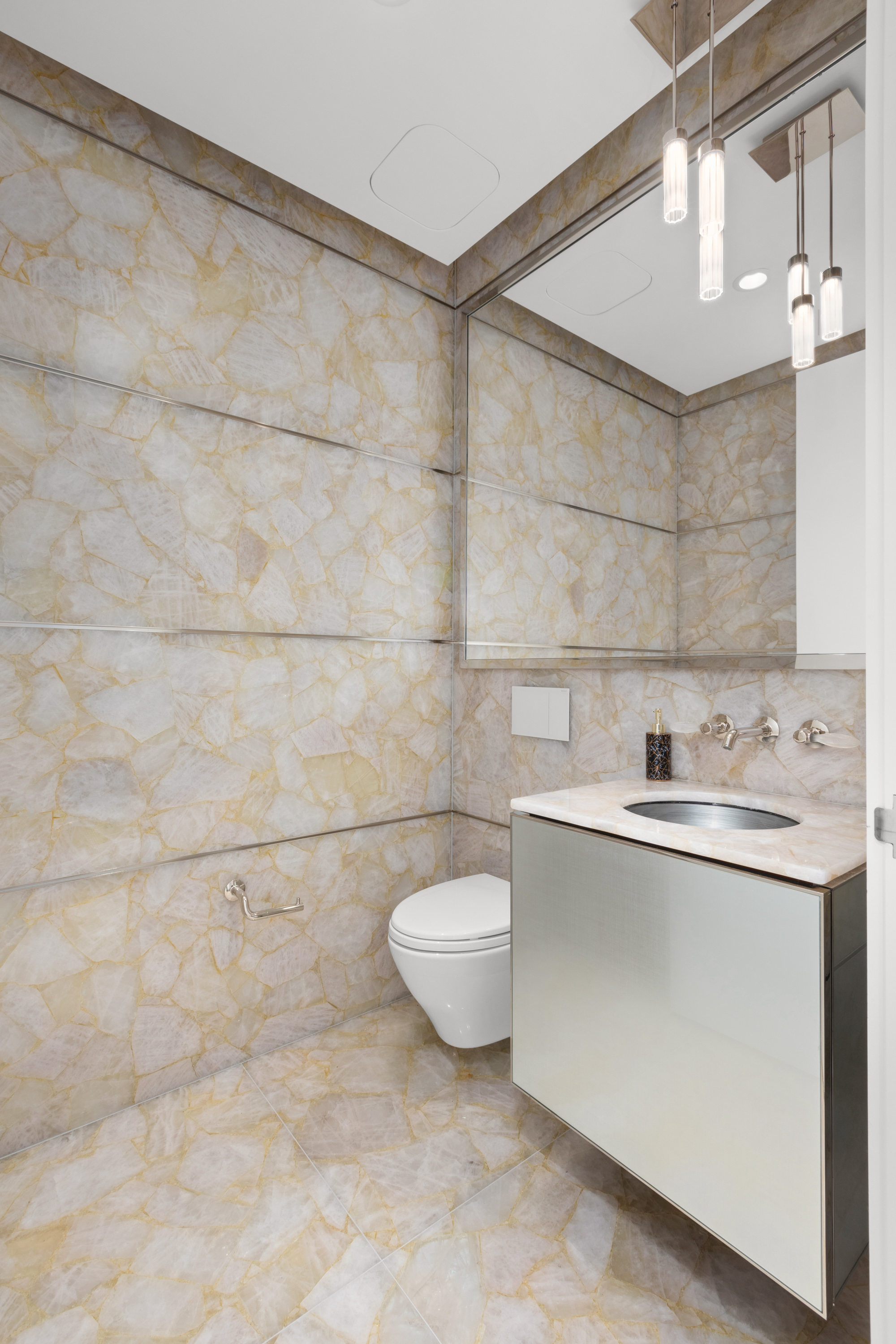 217 West 57th Street, Unit 48D Manhattan, NY 10019 - Photo 8 of 17 a bathroom with a sink a toilet and a mirror
