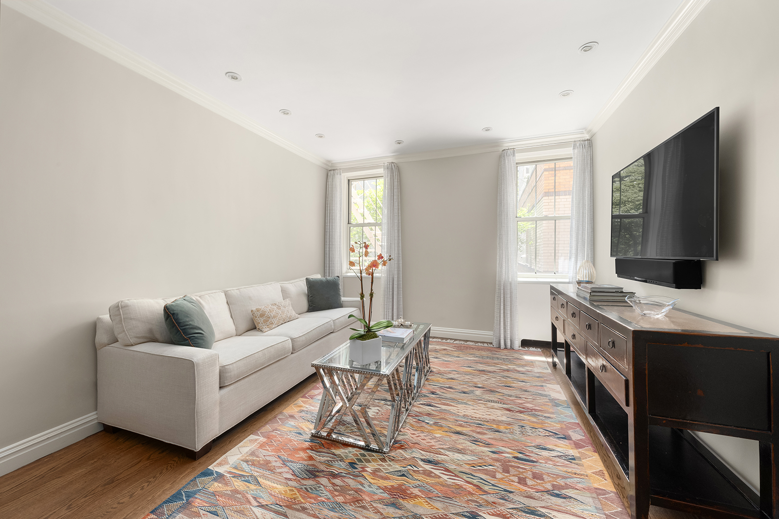 75 Bank Street, Unit 2H Manhattan, NY 10014 - Photo 2 of 18 a living room with furniture and a flat screen tv
