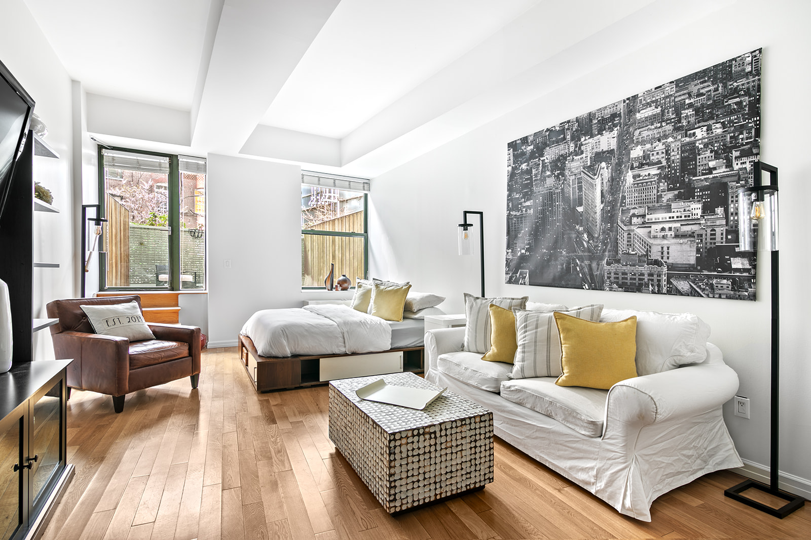99 John Street, Unit 522 Manhattan, NY 10038 - Photo 1 of 11 a living room with furniture and a large window