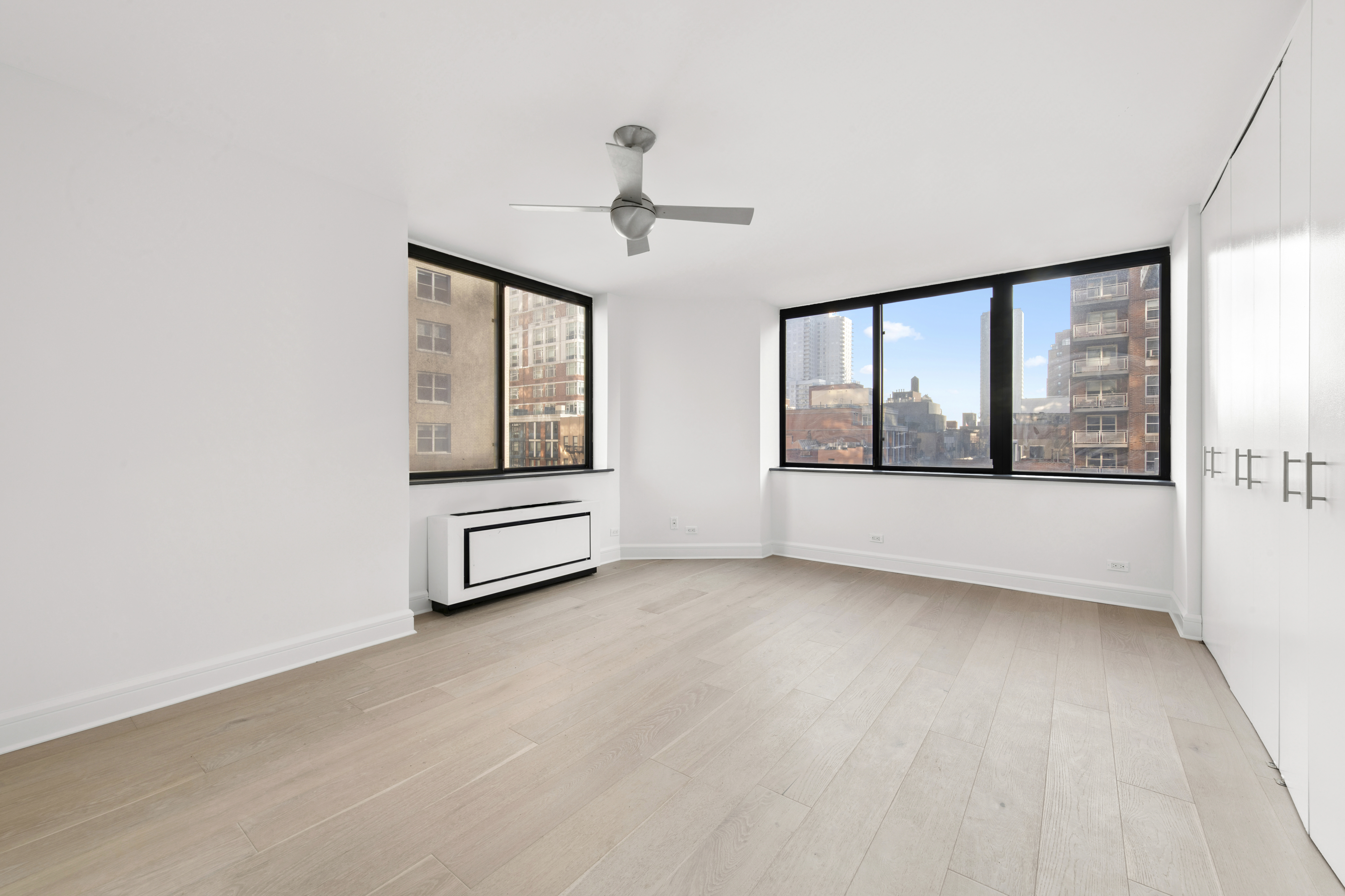 330 East 75th Street, Unit 5B Manhattan, NY 10021 - Photo 6 of 11 wooden floor in an empty room with a window