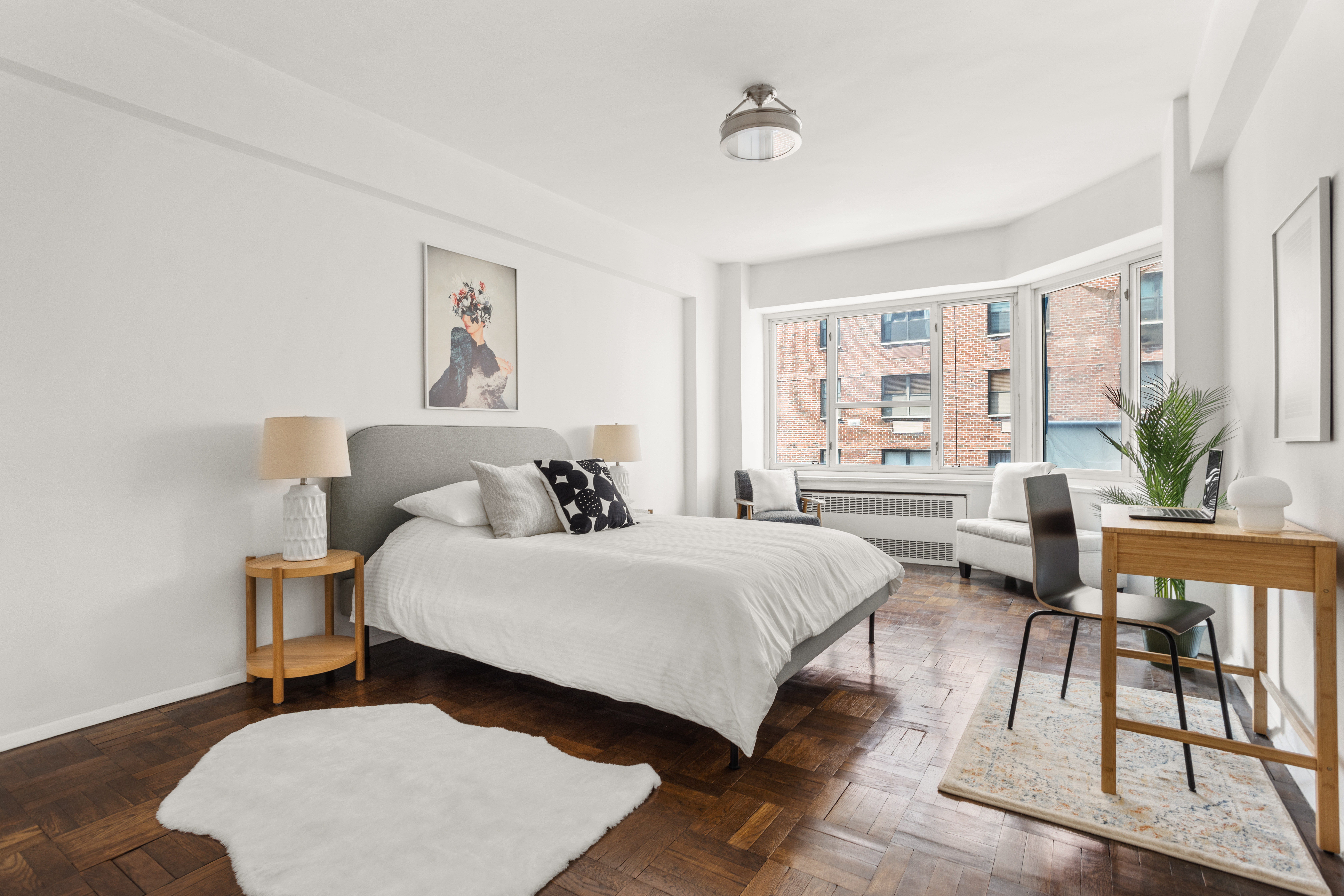 36 Sutton Place South, Unit 11D Manhattan, NY 10022 - Photo 5 of 11 a spacious bedroom with a bed a table and chair