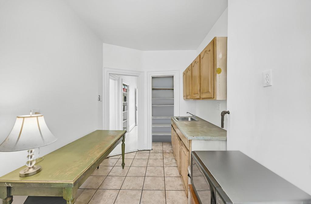 10 Seeley Street Brooklyn, NY 11218 - Photo 21 of 27 a bathroom with a sink a toilet and mirror