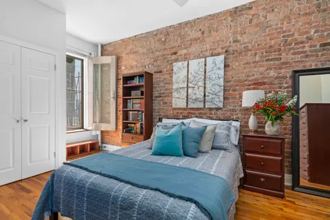 a bedroom with a bed and a potted plant