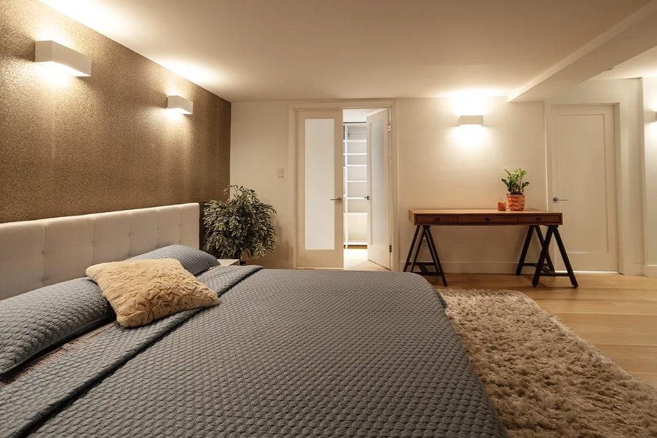 125 East 12th Street, Unit 1E Manhattan, NY 10003 - Photo 10 of 16 a bedroom with a bed and a couch