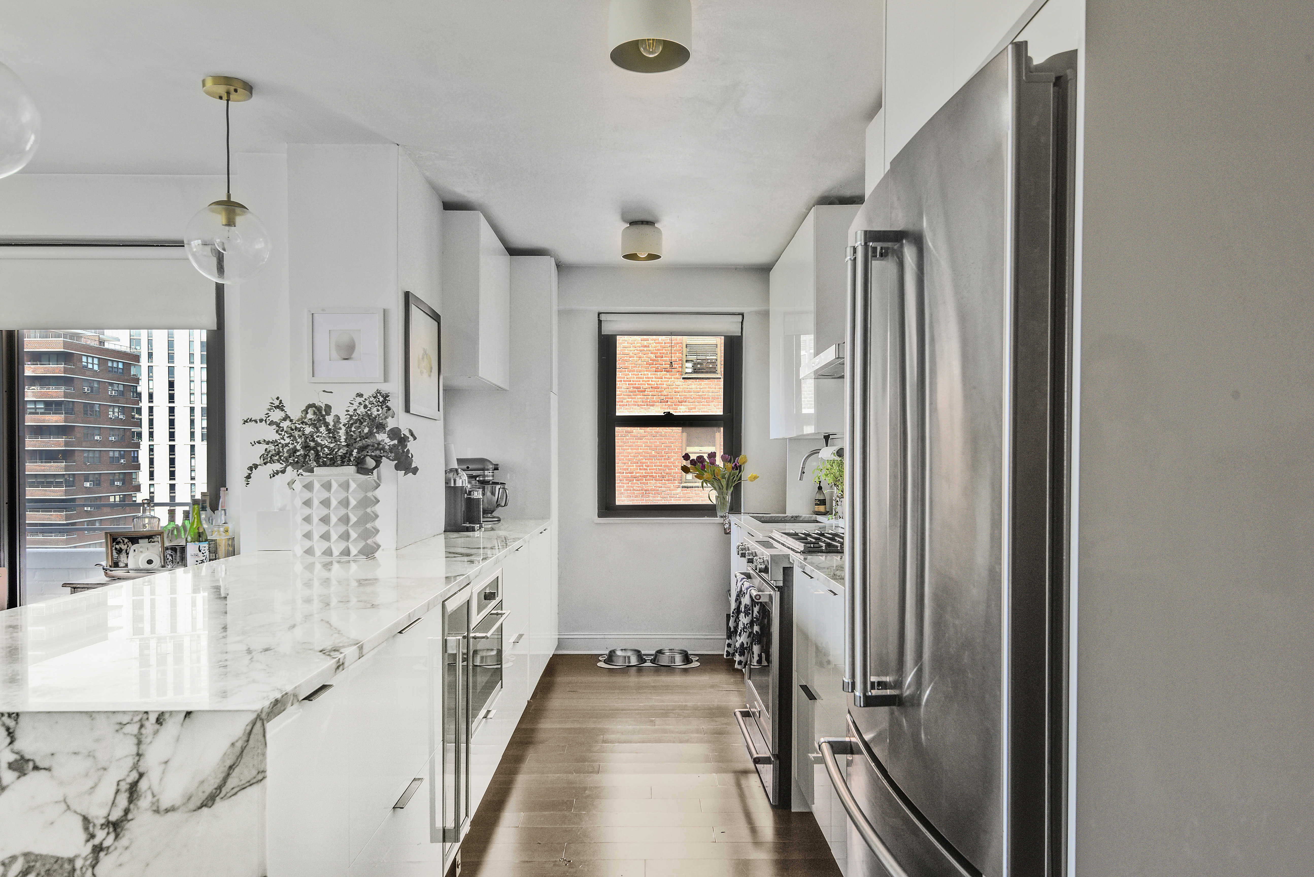 208 East Broadway, Unit J1304 Manhattan, NY 10002 - Photo 5 of 19 a bathroom with a double vanity sink and mirror
