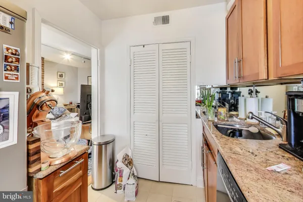 a kitchen with stainless steel appliances granite countertop a sink and a stove