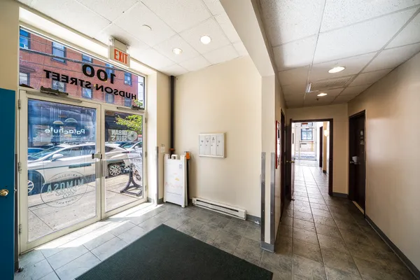a view of a hallway with a hallway and wooden chairs