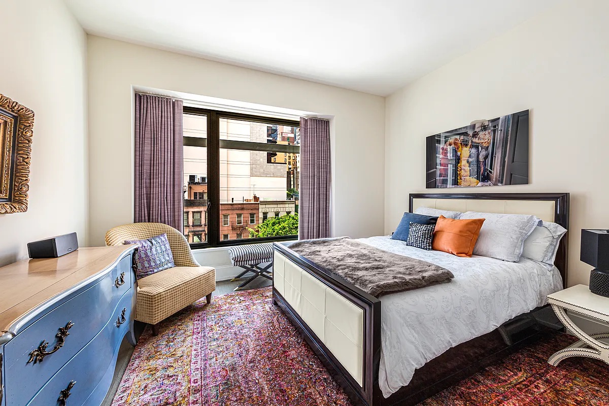 301 East 50th Street, Unit 4B Manhattan, NY 10022 - Photo 4 of 13 a bedroom with a bed and a couch