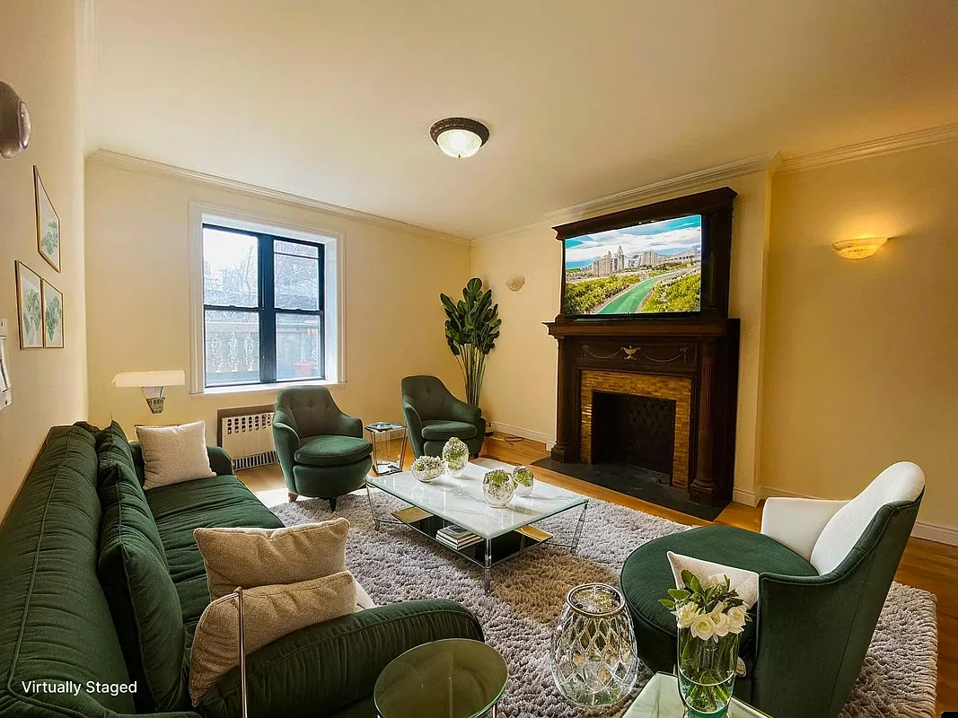 305 West 91st Street, Unit 4F Manhattan, NY 10024 - Photo 1 of 11 a living room with furniture a fireplace and a flat screen tv