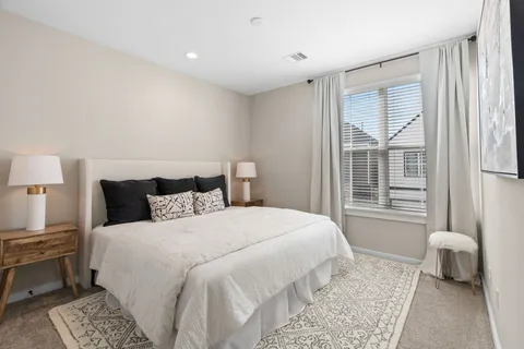 a bedroom with a bed and a couch