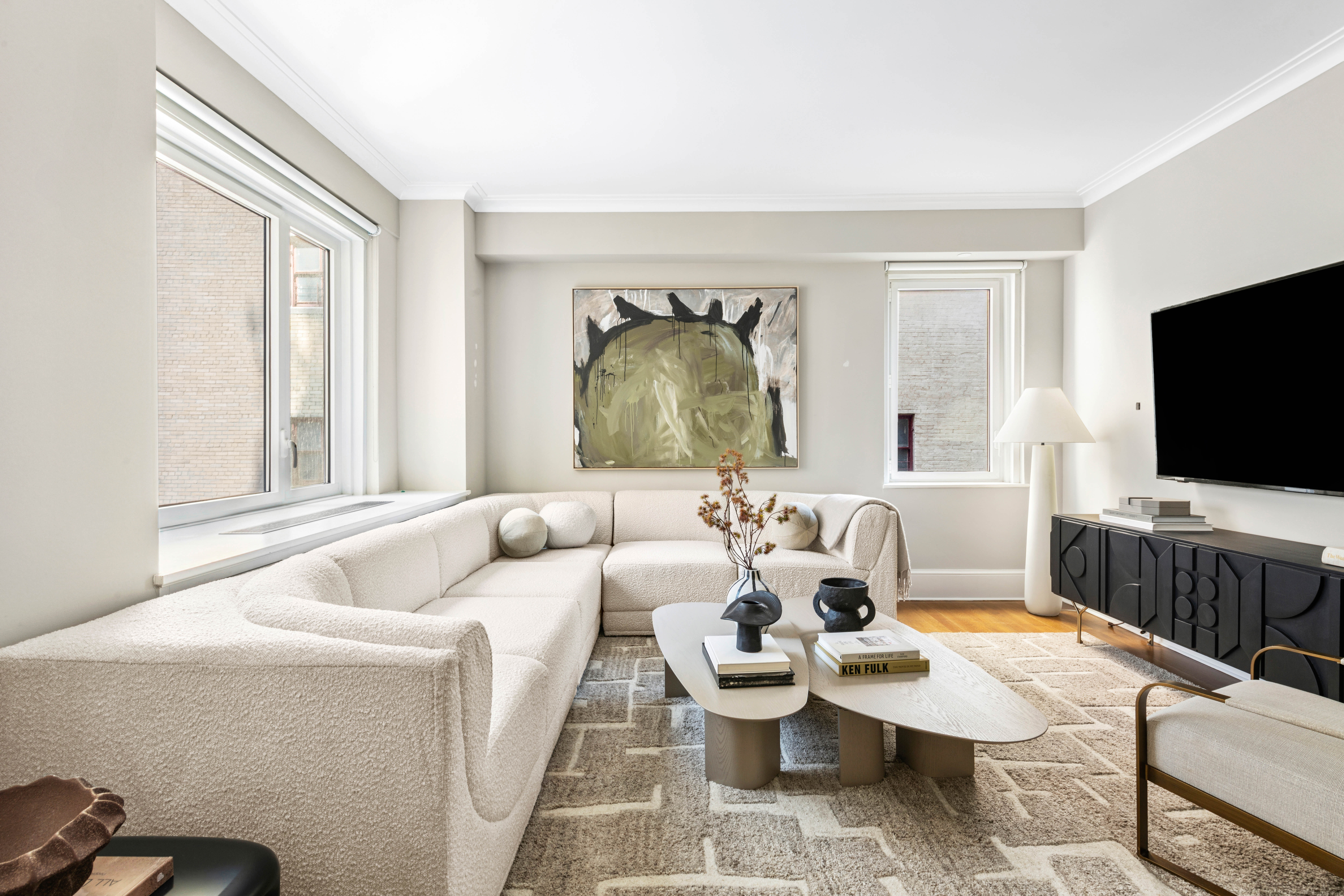 530 Park Avenue, Unit 12F Manhattan, NY 10065 - Photo 6 of 26 a living room with furniture and a flat screen tv