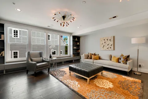 a living room with furniture rug and window