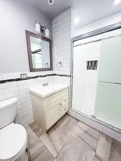 a bathroom with a sink toilet and shower