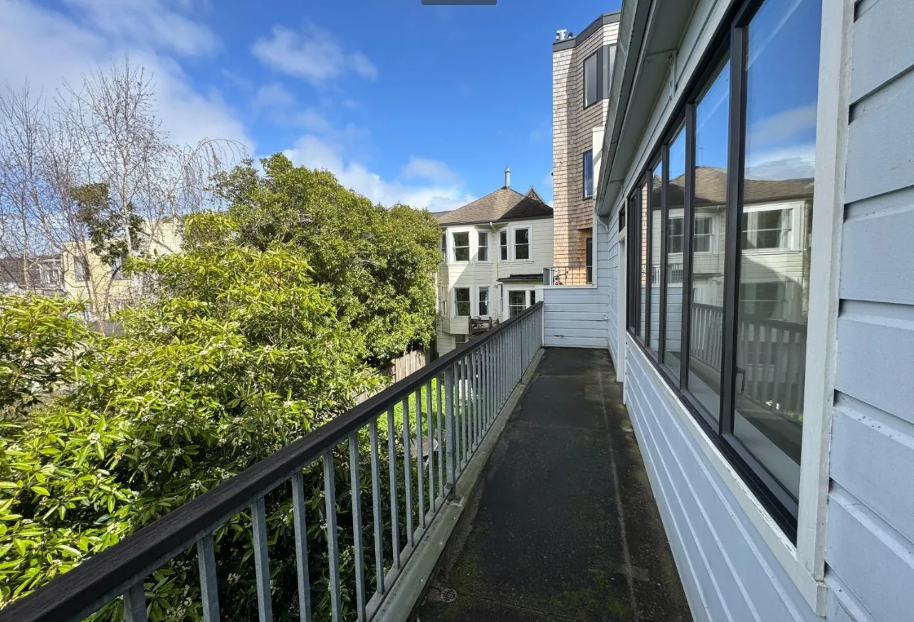 a view of a house with a street from a balcony