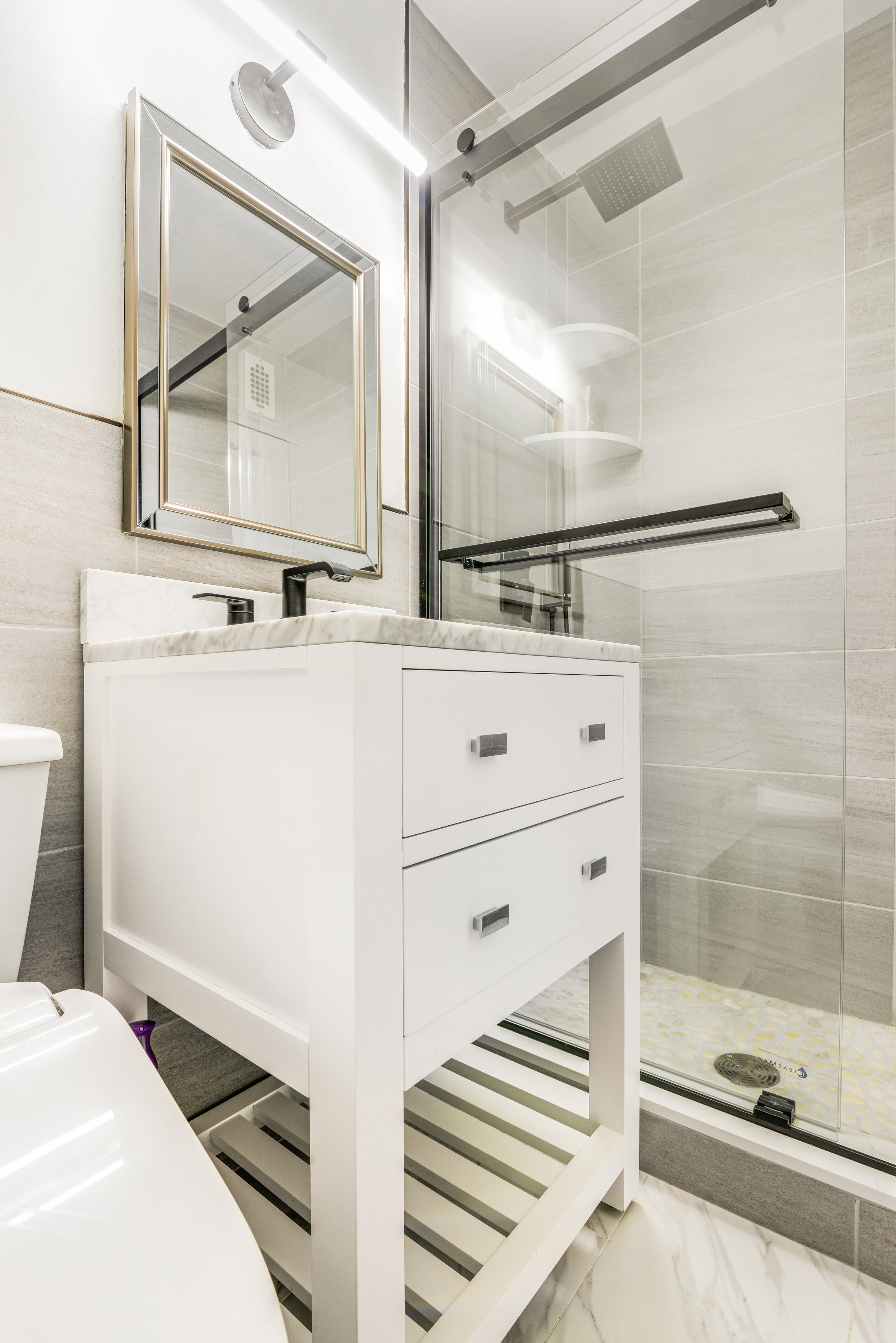 155 West 68th Street, Unit 1907 Manhattan, NY 10023 - Photo 5 of 20 a bathroom with a sink and a mirror