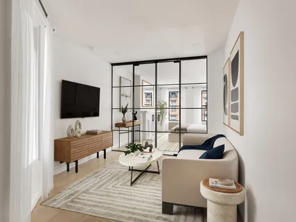 a living room with furniture a flat screen tv and a window