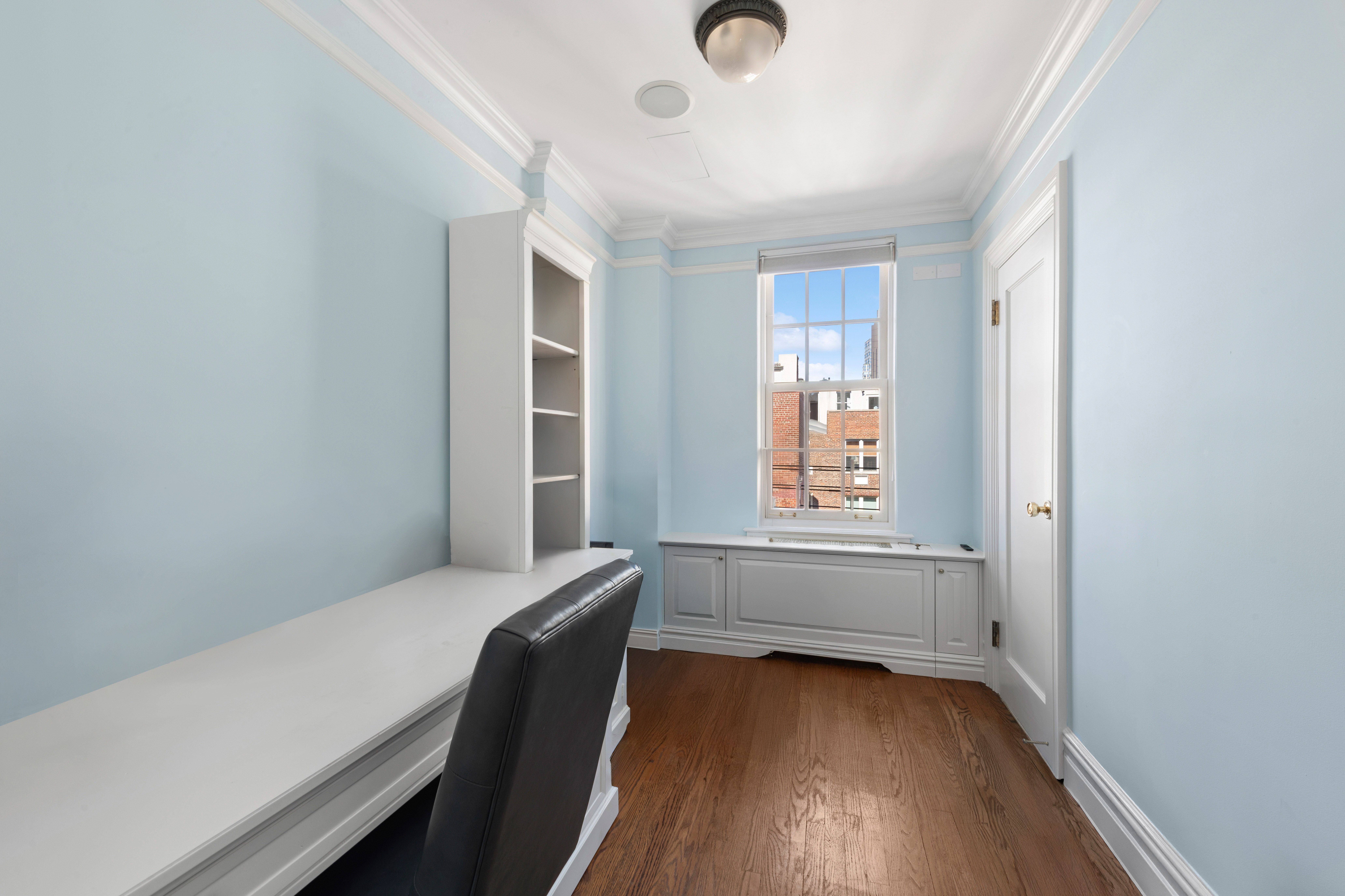 1140 5th Avenue, Unit 14B Manhattan, NY 10128 - Photo 10 of 18 a room with window and wooden floor