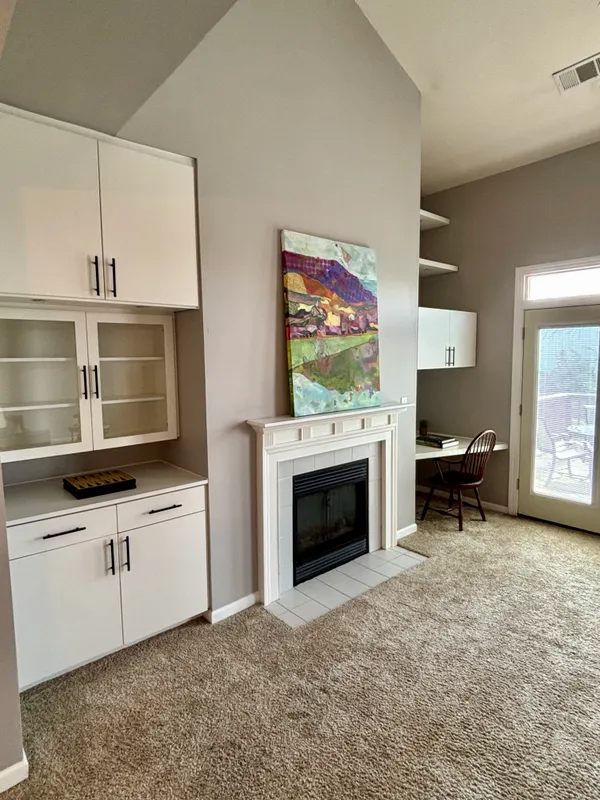 a kitchen with stainless steel appliances a stove and a fireplace