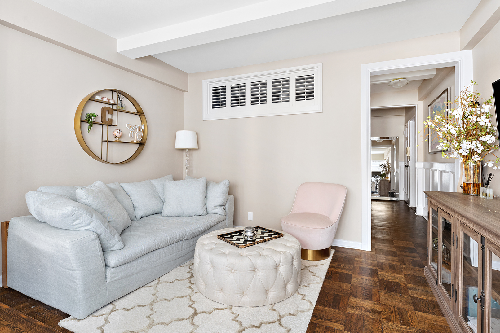 7 Lexington Avenue, Unit 9F Manhattan, NY 10010 - Photo 2 of 8 a living room with furniture and a large mirror