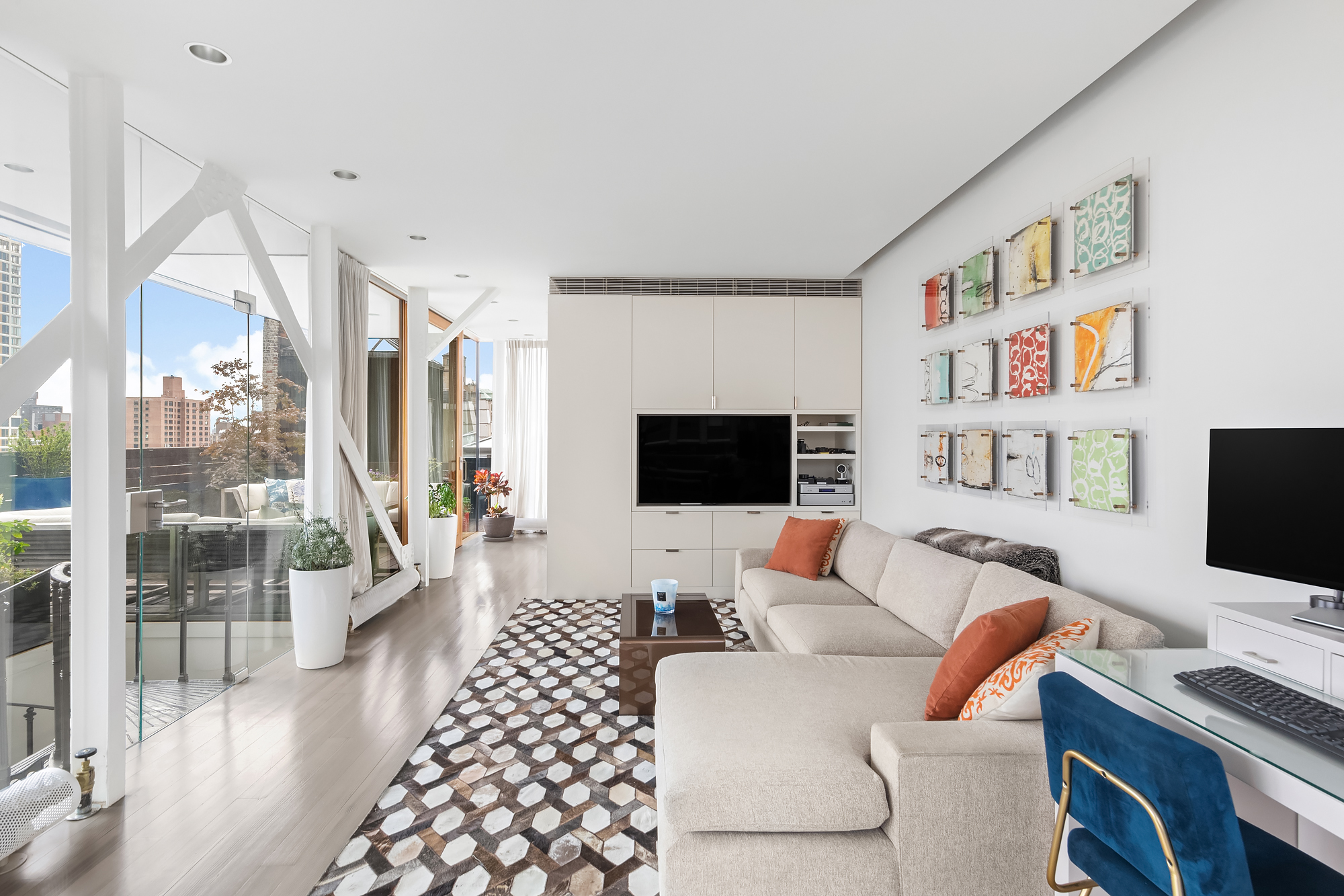 105 East 29th Street, Unit 12PH Manhattan, NY 10016 - Photo 19 of 24 a living room with furniture and a flat screen tv