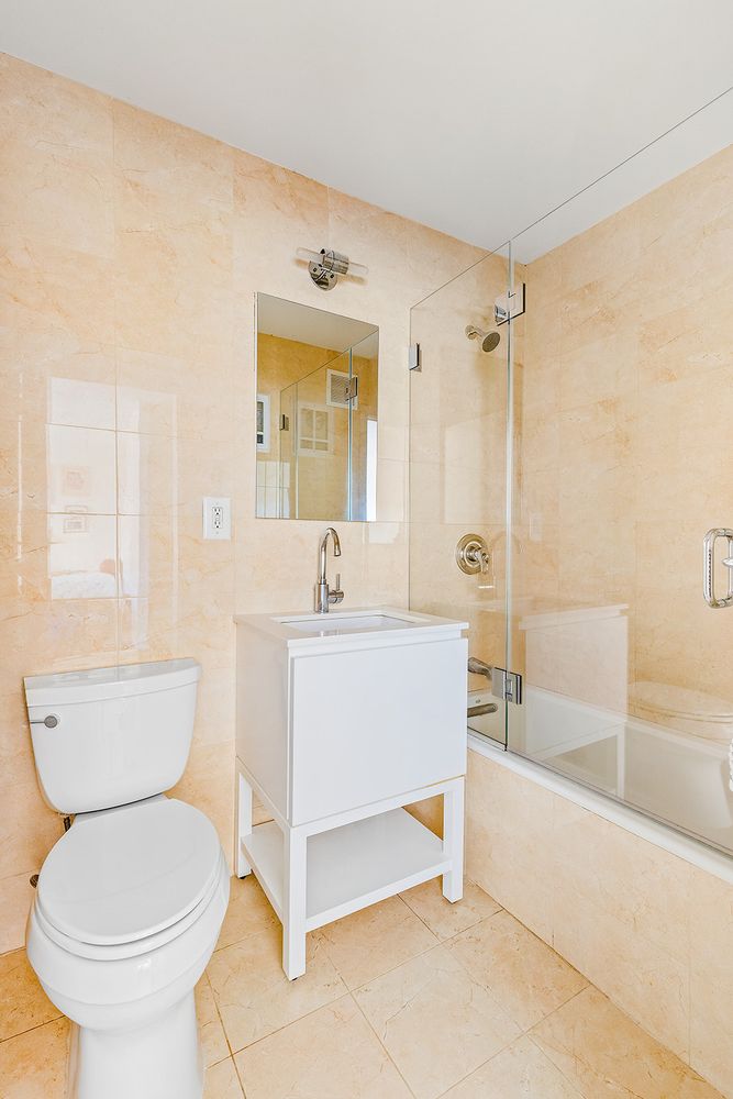 a bathroom with a sink a toilet and bathtub