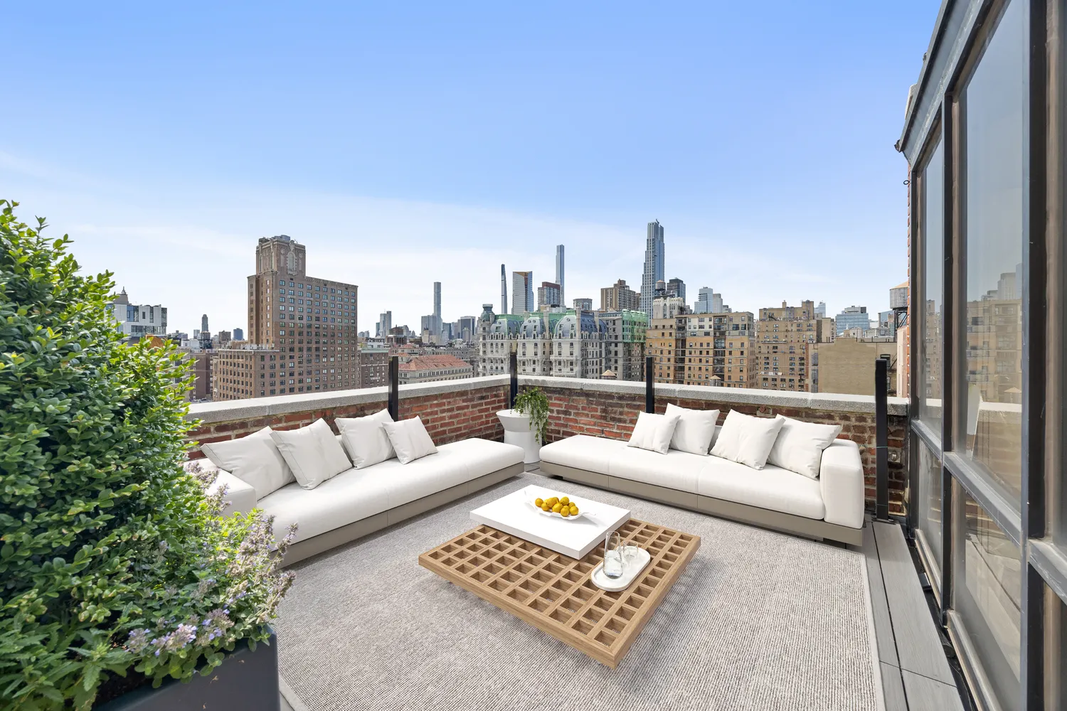 a view of roof with furniture and city view