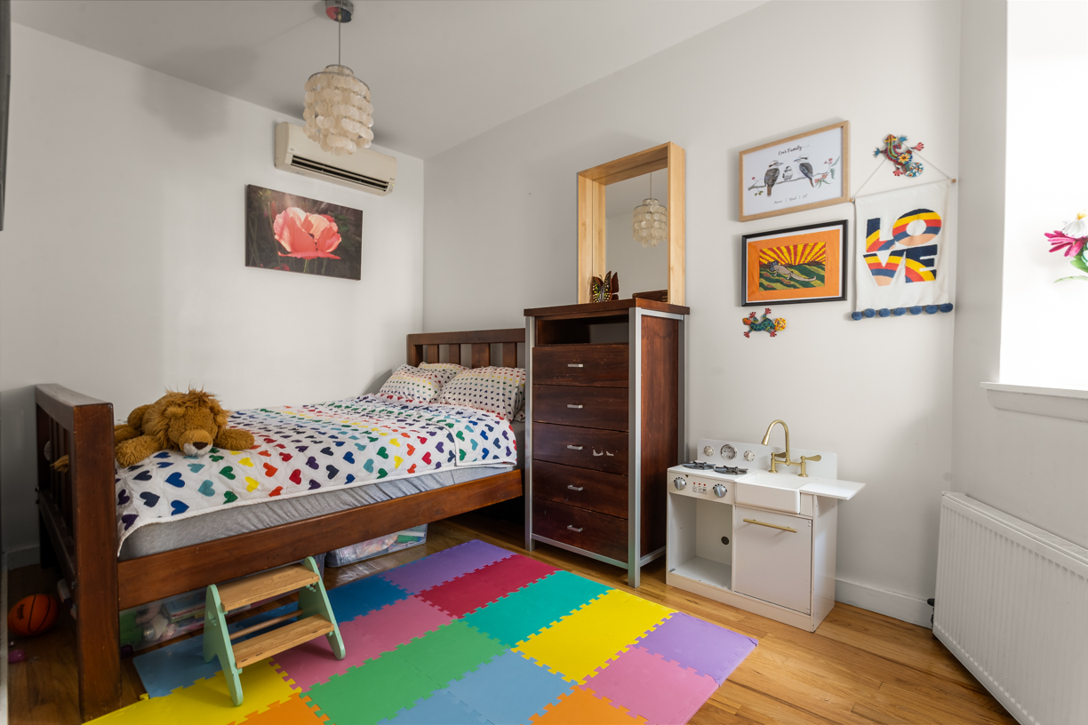 119 East 101st Street, Unit 1A Manhattan, NY 10029 - Photo 7 of 10 a bedroom with a bed and a dresser in it