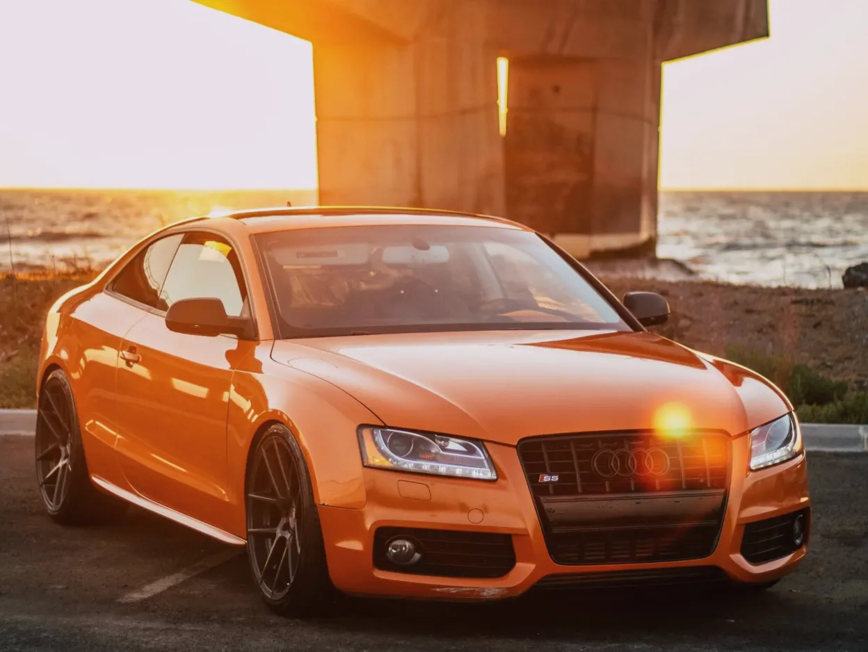 a blue car parked in front of a building