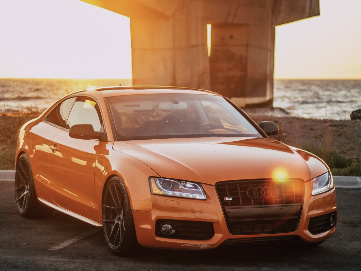 a blue car parked in front of a building