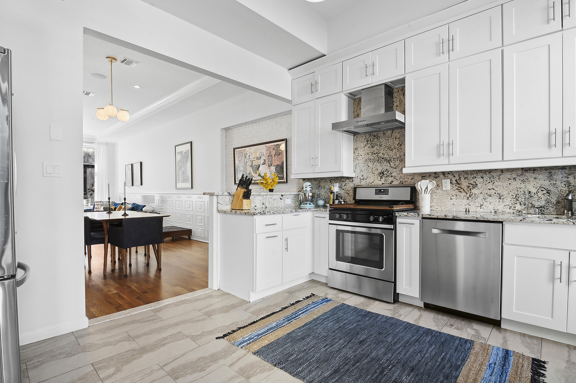 147 Herkimer Street Brooklyn, NY 11216 - Photo 6 of 25 a kitchen with cabinets and wooden floor