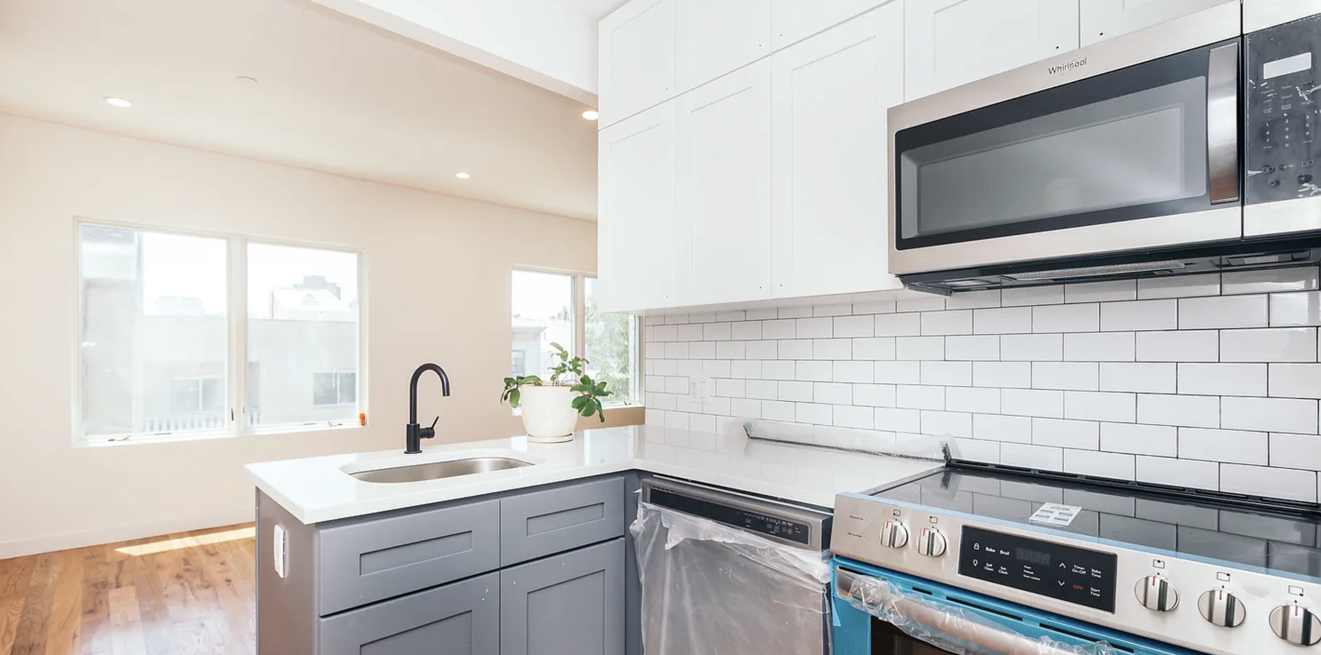 a kitchen with a stove microwave and sink
