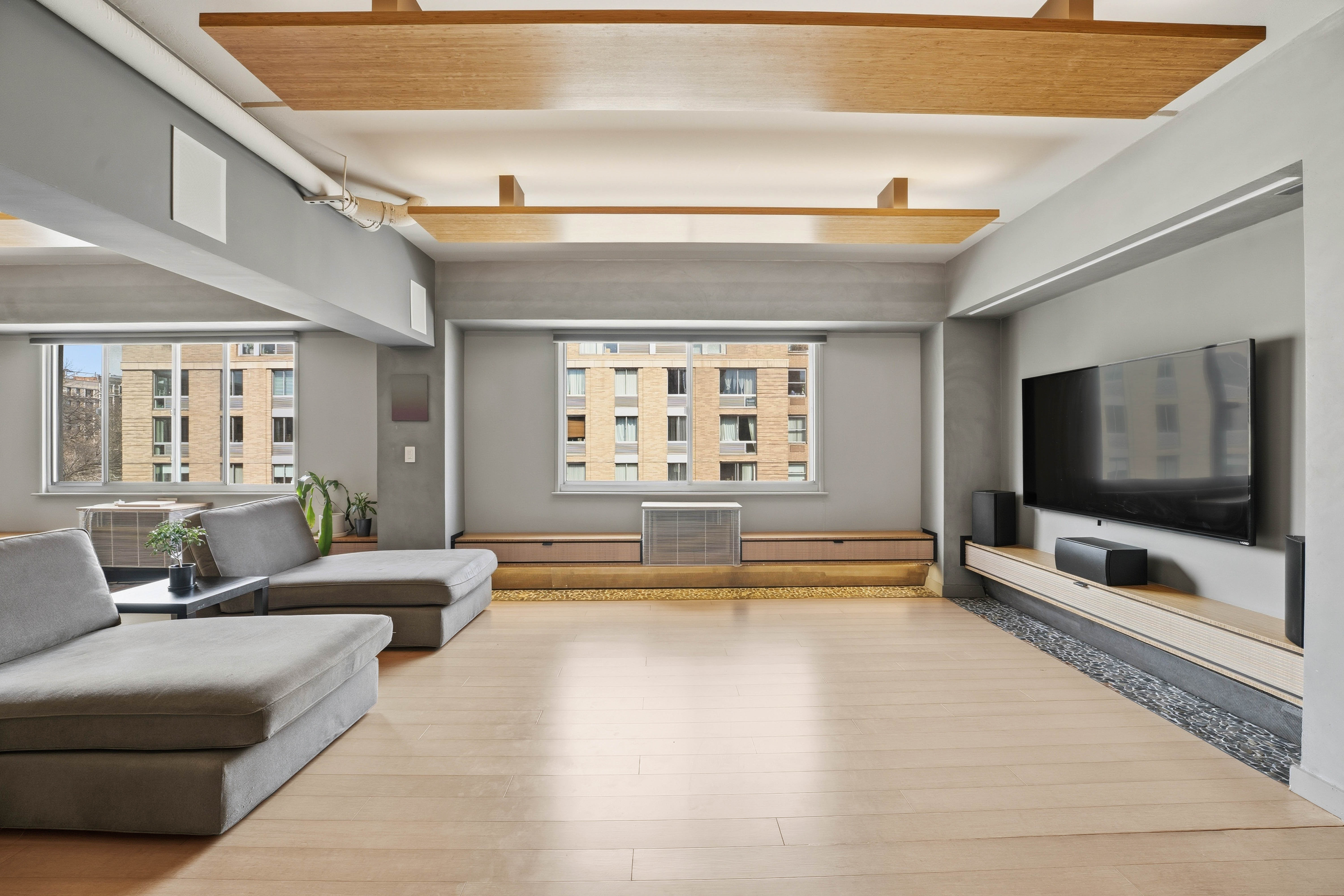 300 West 145th Street, Unit 6G Manhattan, NY 10039 - Photo 13 of 19 a living room with furniture and a flat screen tv