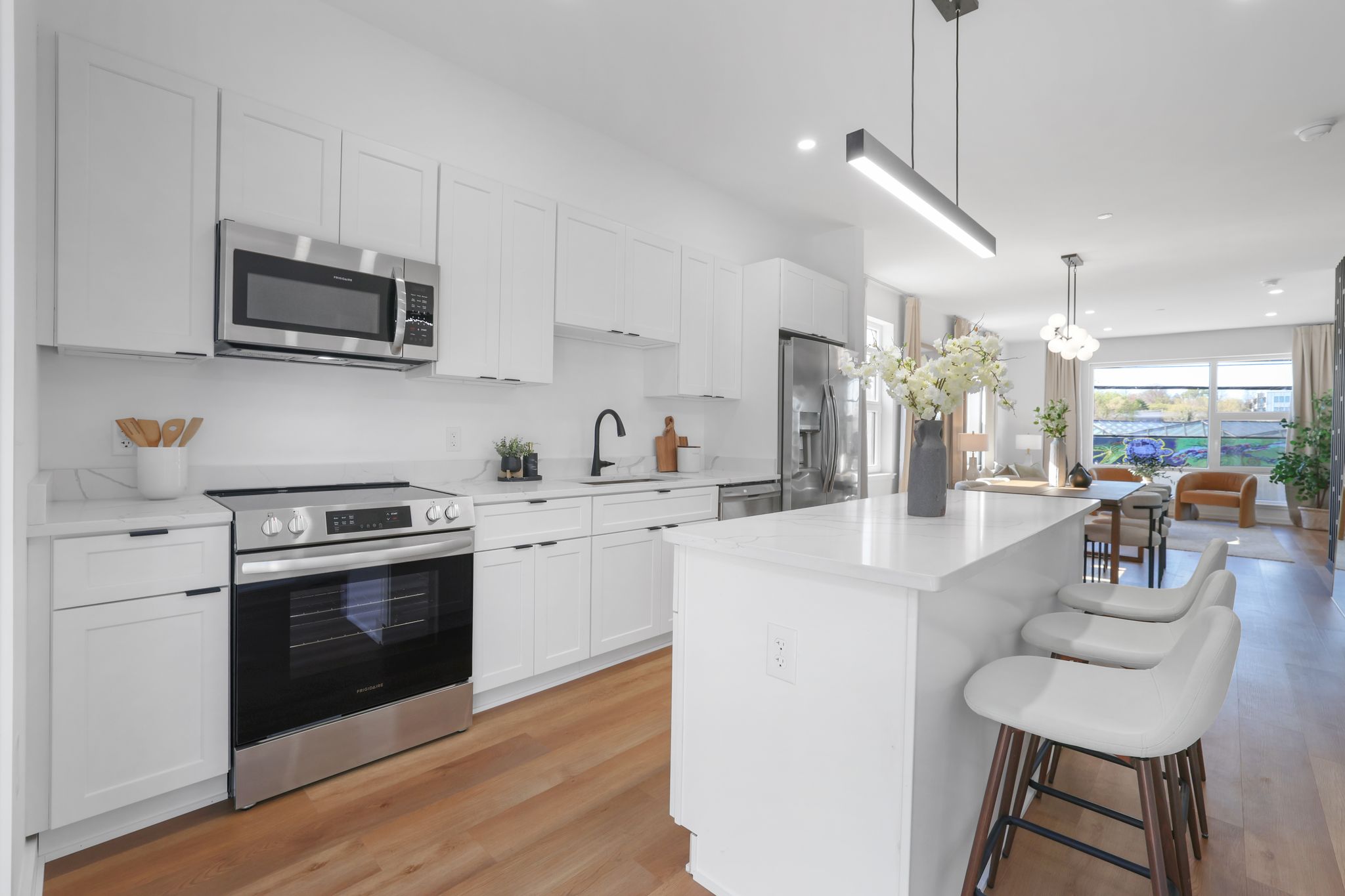 1036 Howard Road Southeast Washington, DC 20020 - Photo 22 of 41 a kitchen with stainless steel appliances granite countertop a sink a stove a microwave oven a refrigerator with white cabinets and wooden floor