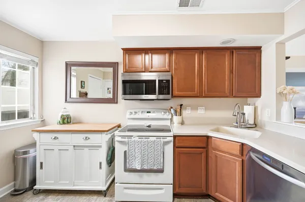 a kitchen with a sink stove oven and cabinets