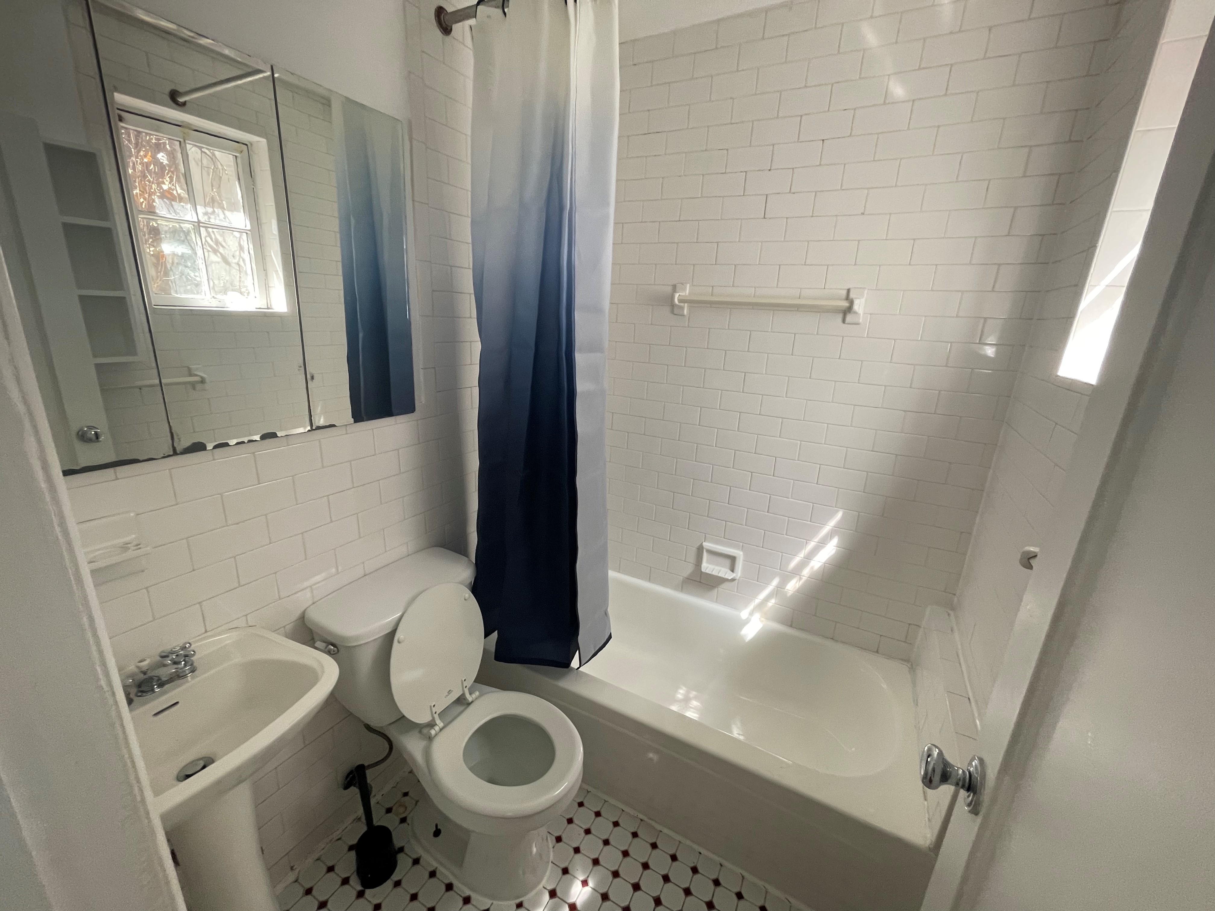120 East 10th Street, Unit 1 Manhattan, NY 10003 - Photo 4 of 24 a bathroom with a granite countertop sink and a mirror