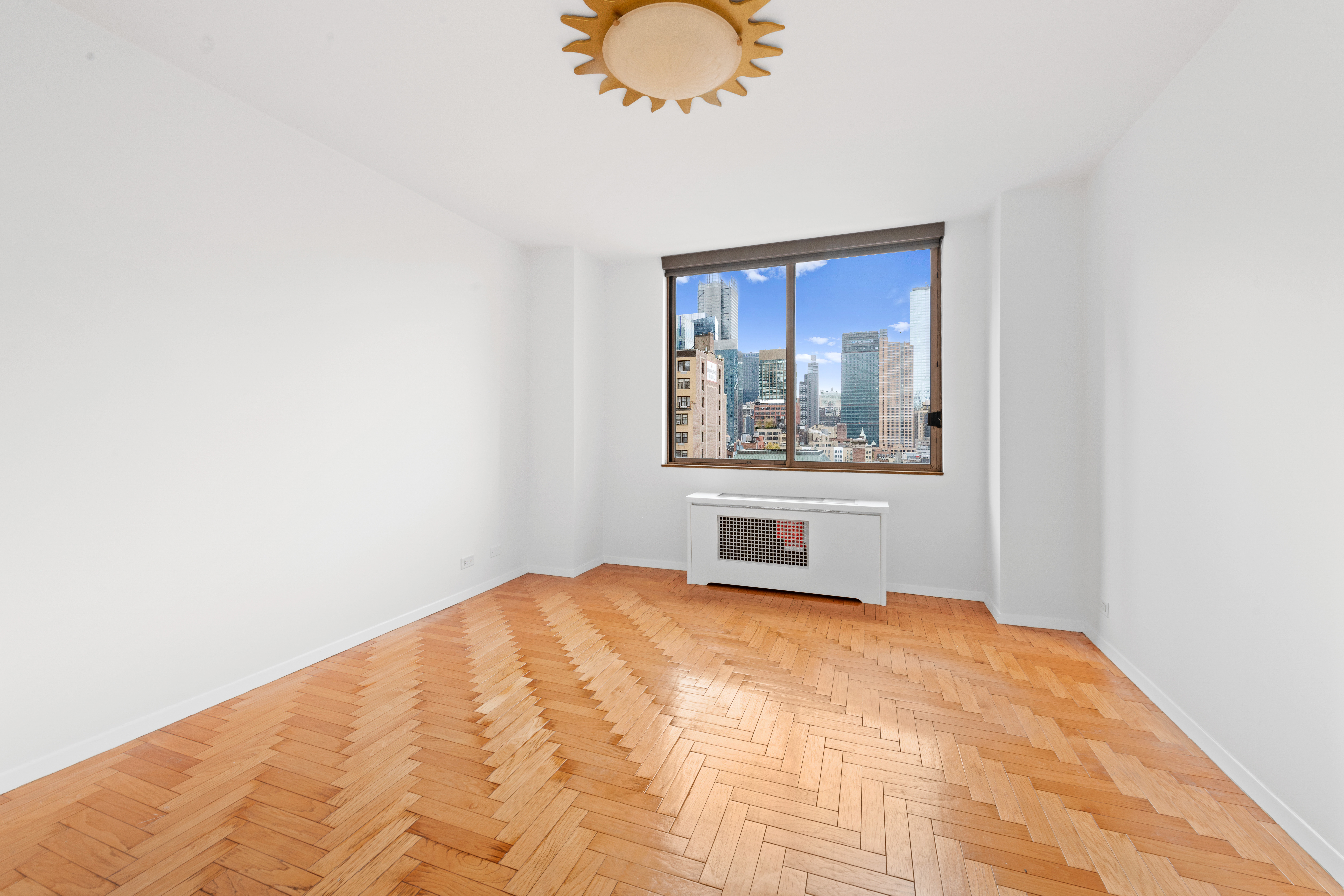 350 West 50th Street, Unit 12B Manhattan, NY 10019 - Photo 8 of 16 a bedroom with a bed and a window